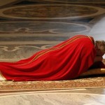 Pope Francis lies as he prays during the Celebration of the Lord’s Passion in Saint Peter’s Basilica at the Vatican